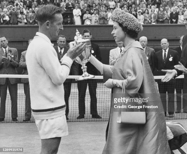 Rod Laver of Australia is presented with the Gentlemen's Singles Trophy by HRH Queen Elizabeth II after defeating compatriot Martin Mulligan in the...