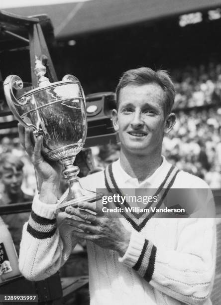 Rod Laver of Australia with the Gentlemen's Singles Trophy after defeating Chuck McKinley of the United States in the Men's Singles Final match at...