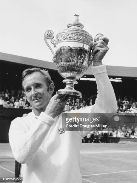 Rod Laver of Australia with the Gentlemen's Singles Trophy after defeating compatriot John Newcombe in the Men's Singles Final match at the Wimbledon...