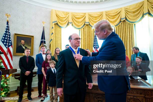 President Donald Trump presents the Presidential Medal of Freedom to Dan Gable in the Oval Office on December 07, 2020 in Washington, DC. Gable is a...