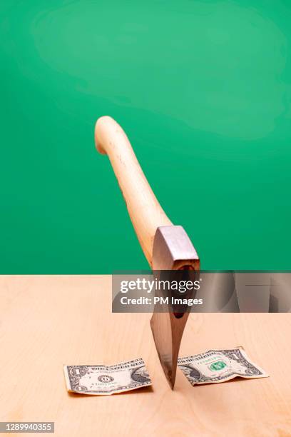 dollar chopped by axe - stock photo - budget cuts stock-fotos und bilder