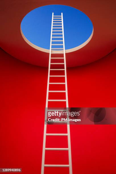 escape - ladder to a hole - stock photo - conceptual bold red stock-fotos und bilder