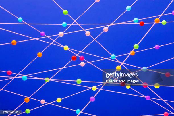 multi colored balls on strings - intelligence community stock pictures, royalty-free photos & images