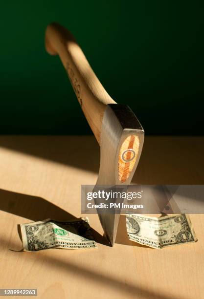 dollar chopped by axe - austerity imagens e fotografias de stock