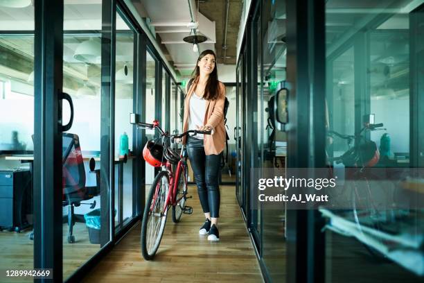 businesswoman arriving to work on bike - healthy office stock pictures, royalty-free photos & images