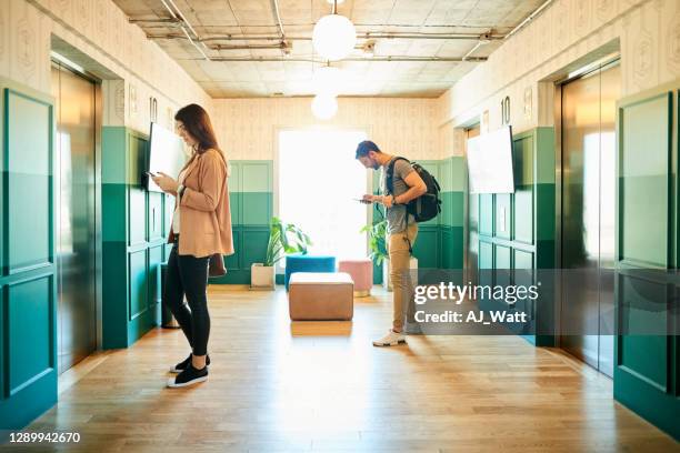 people waiting for elevator - waiting for elevator stock pictures, royalty-free photos & images