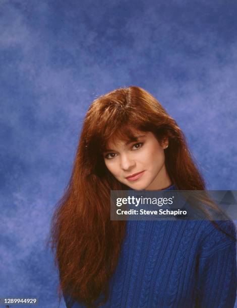 Portrait of American actress Valerie Bertinelli as she poses against a blue background, Los Angeles, California, 1990.