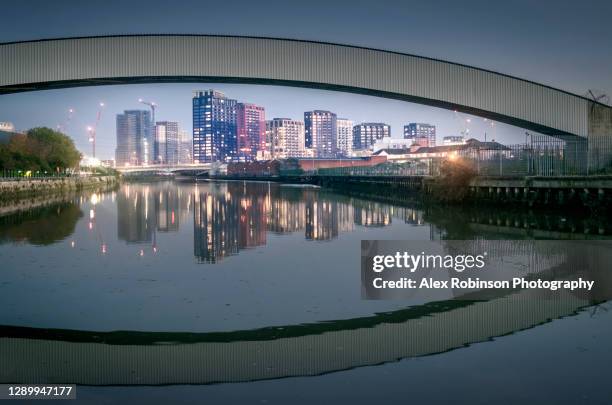 new build apartments and an industrial landscape around the lea river in newham, london - stratford london fotografías e imágenes de stock