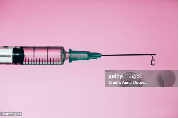 syringe with drop of medicine - injection ストックフォトと画像