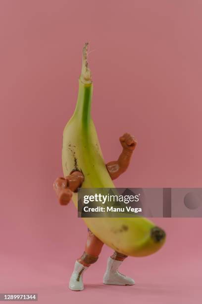 raw banana with arms and legs doing a fighting pose - banana split stock pictures, royalty-free photos & images