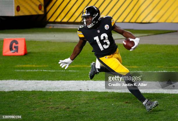 James Washington of the Pittsburgh Steelers carries the ball in for a touchdown following a reception during the second quarter of their game against...