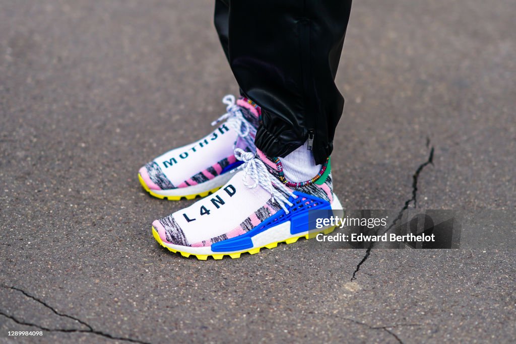 A guest wears Pharrell Williams x Adidas NMD HU Solarhu 'MOTH3R & News  Photo - Getty Images