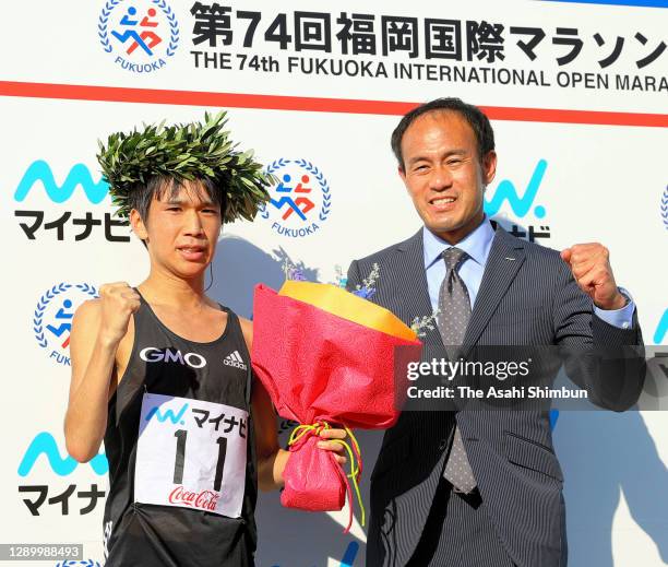 Yuya Yoshida and his coach Katsuhiko Hanada pose for photographs after winning the 74th Fukuoka International Marathon at the Heiwadai Athletic...