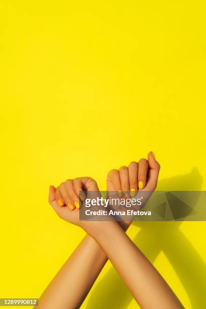 trendy yellow and orange manicure. trendy manicure of the year - multi coloured nails stock pictures, royalty-free photos & images