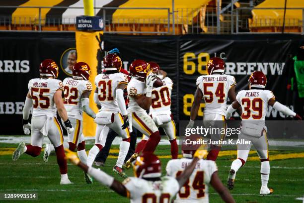 Jon Bostic of the Washington Football Team celebrates with teammates following an interception during the fourth quarter of their game against the...