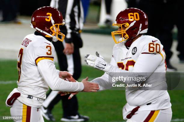 Dustin Hopkins of the Washington Football Team celebrates with Keith Ismael following a field goal during the second half of their game against the...