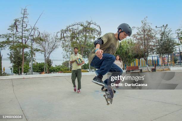 friends skating in skate park - skateboarder and helmet stock pictures, royalty-free photos & images