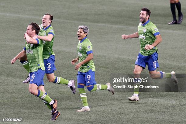 Gustav Svensson of Seattle Sounders celebrates his winning goal with Brad Smith, Raul Ruidiaz and Will Bruin against the Minnesota United in the...