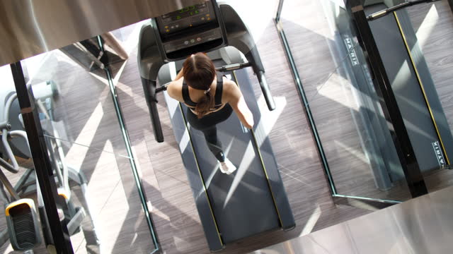 Woman Running at Treadmill ,New Normal and Modern Gym