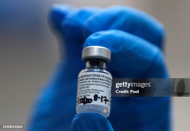 Nurse holds a phial of the Pfizer-BioNTech COVID-19 vaccine at Guy's Hospital at the start of the largest ever immunisation programme in the UK's...