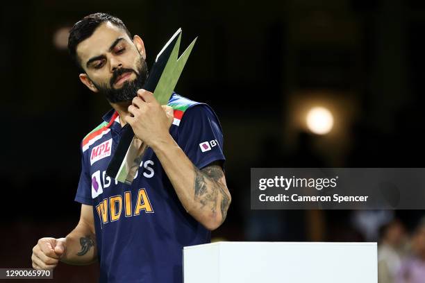 Virat Kohli of India collects the T20 Trophy following game three of the Twenty20 International series between Australia and India at Sydney Cricket...