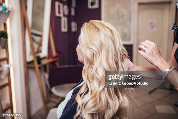 woman with protective mask receiving treatment in hair salon - blonde hair dye stock pictures, royalty-free photos & images
