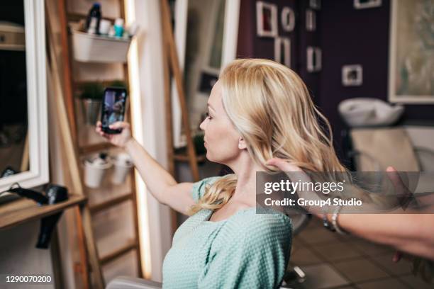 woman with protective mask receiving treatment in hair salon - blonde hair dye stock pictures, royalty-free photos & images