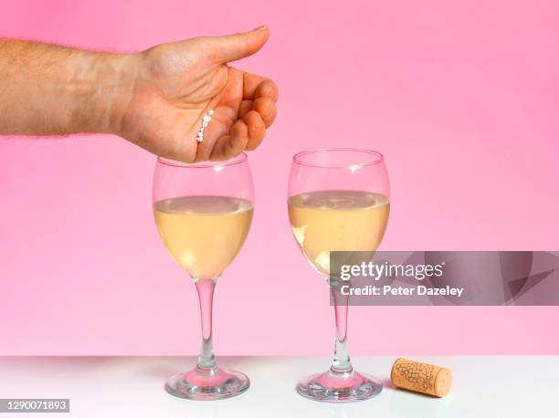 unattended drink being spiked with drugs - crime or recreational drug or prison or legal trial stock pictures, royalty-free photos & images