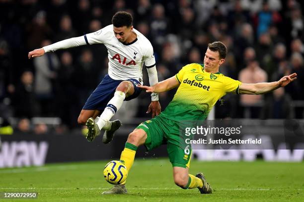 Dele Alli of Tottenham Hotspur is tackled by Christoph Zimmermann of Norwich City during the Premier League match between Tottenham Hotspur and...