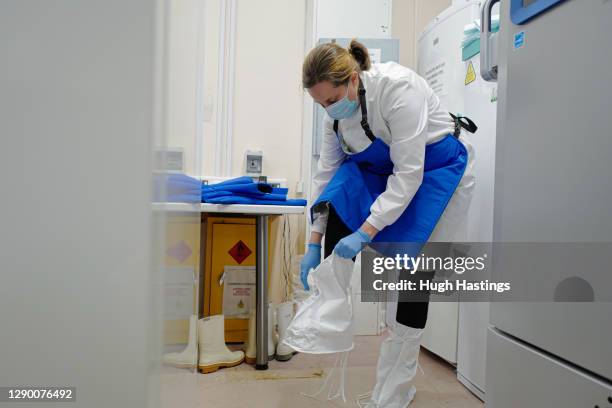 Alison Hill, Principal Pharmacist Applied Services gets kitted out to open one of two cryogenic freezers storing the covid-19 vaccinations at the...