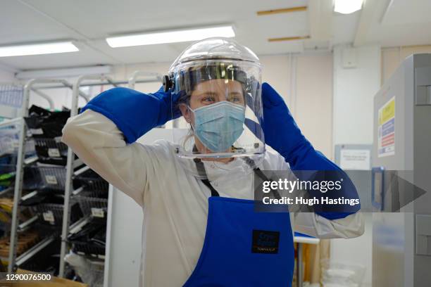 Alison Hill, Principal Pharmacist Applied Services gets kitted out to open one of two cryogenic freezers storing the covid-19 vaccinations at the...