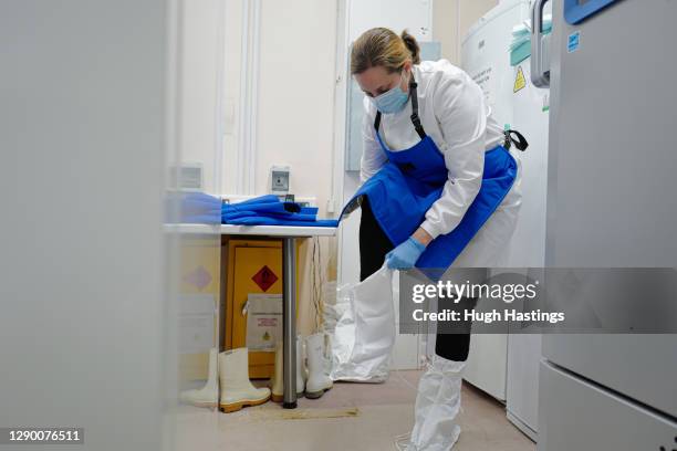 Alison Hill, Principal Pharmacist Applied Services gets kitted out to open one of two cryogenic freezers storing the covid-19 vaccinations at the...