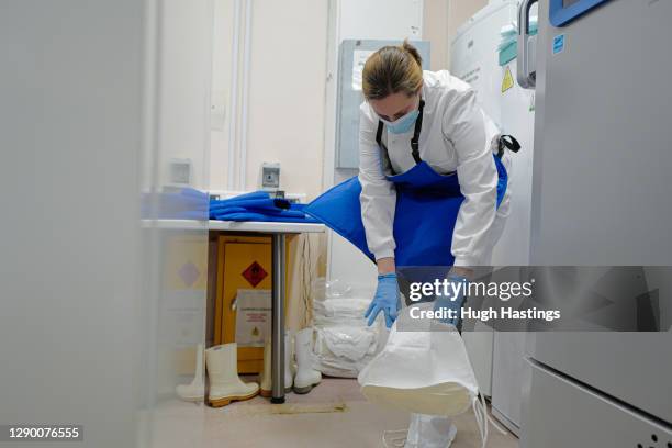 Alison Hill, Principal Pharmacist Applied Services gets kitted out to open one of two cryogenic freezers storing the covid-19 vaccinations at the...