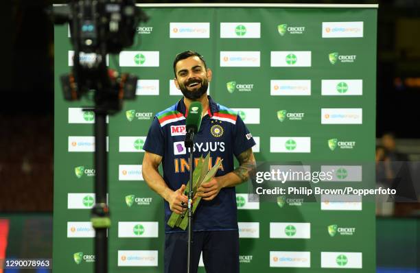 Virat Kohli of India holds the series trophy as he is interviewed after game three of the Twenty20 International series between Australia and India...