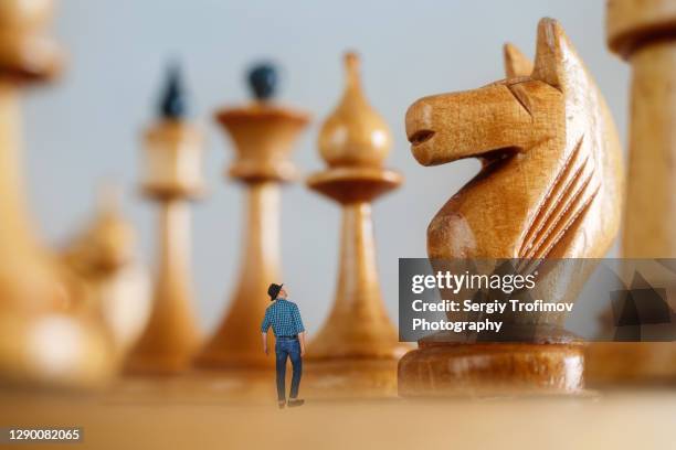 Small Female Figure Surrounded By Huge Chess Pieces Within An Ornate Old  Building Stock Photo - Download Image Now - iStock