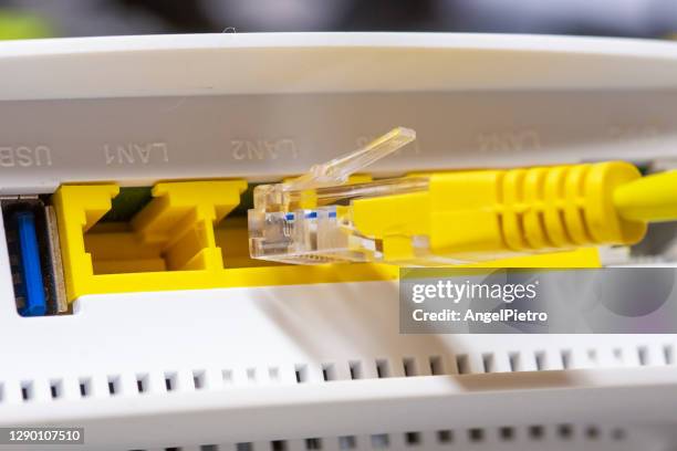 electronic sex - network cable connecting to the input of a router. metaphor in times of virtual reality - modem stock-fotos und bilder