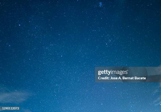 full frame of blue sky at night with stars and some tall clouds. - evening foto e immagini stock