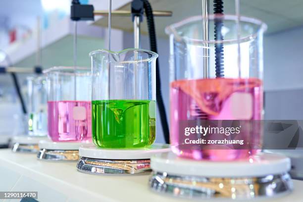 stirring liquid in beaker - chemical reaction stock pictures, royalty-free photos & images
