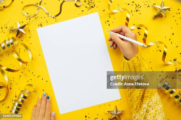 hands writing new year goals - woman on gray background stock pictures, royalty-free photos & images