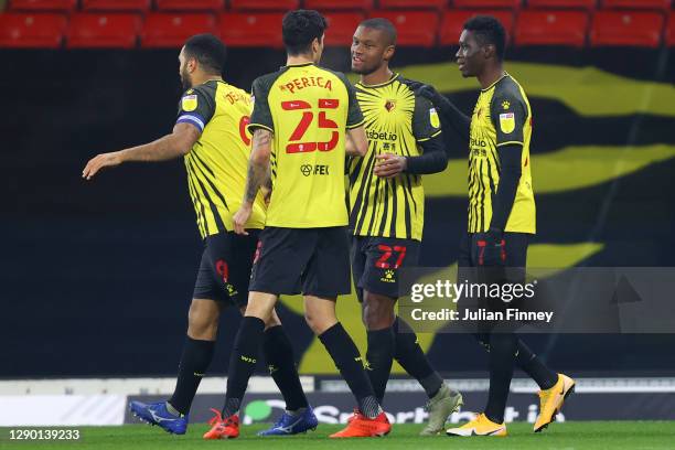 Christian Kabasele of Watford celebrates with teammates after scoring their team's first goal during the Sky Bet Championship match between Watford...