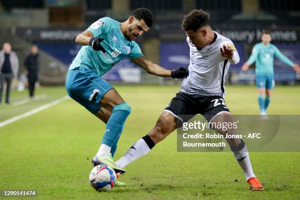Joel Latibeaudiere of Swansea City holds up Dominic Solanke of Bournemouth during the Sky Bet Championship match between Swansea City and AFC...
