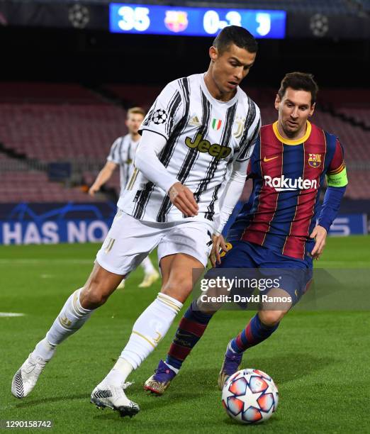 Cristiano Ronaldo of Juventus F.C. Is put under pressure by Lionel Messi of Barcelona during the UEFA Champions League Group G stage match between FC...