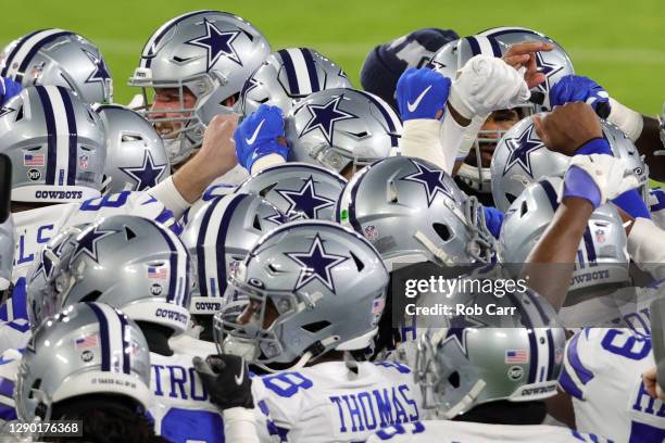 The Dallas Cowboys huddle up before playing against the Baltimore Ravens at M&T Bank Stadium on December 8, 2020 in Baltimore, Maryland.