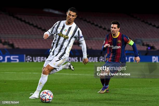 Cristiano Ronaldo of Juventus F.C. Is put under pressure by Lionel Messi of Barcelona during the UEFA Champions League Group G stage match between FC...