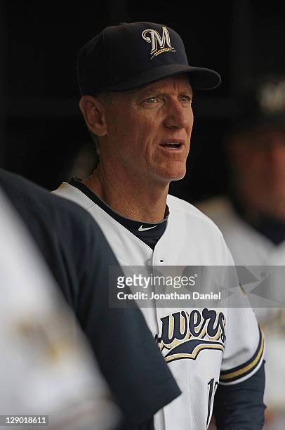 Manager Ron Roenicke of the Milwaukee Brewers waits in the dugout for the start of Game Five of the National League Division Series against the...