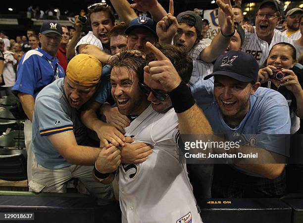 Taylor Green of the Milwaukee Brewers celebrates with fans after a win over the Arizona Diamondbacks during Game Five of the National League Division...