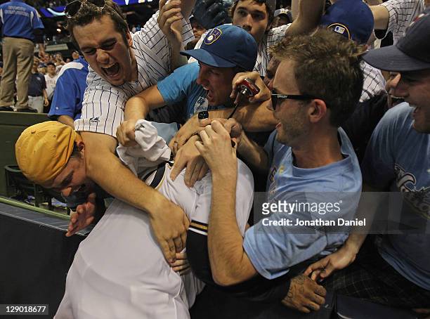 Prince Fielder of the Milwaukee Brewers celebrates with fans after a win over the Arizona Diamondbacks during Game Five of the National League...
