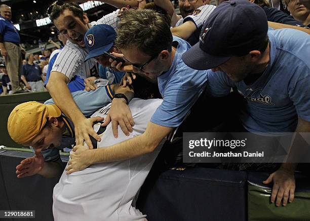 Prince Fielder of the Milwaukee Brewers celebrates with fans after a win over the Arizona Diamondbacks during Game Five of the National League...