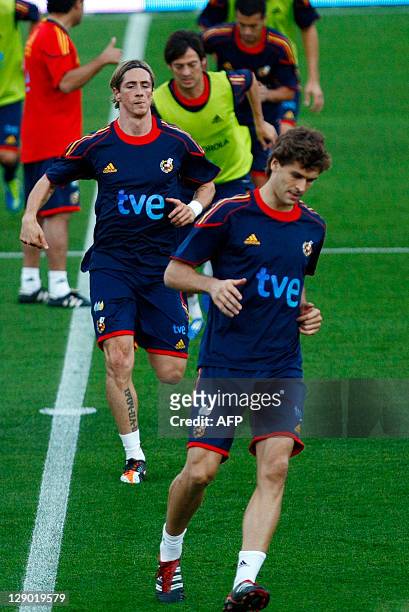 Spain's forward Fernando Torres and Spain's forward Fernando Llorente run during a training session in Alicante on October 10 on the eve of their...