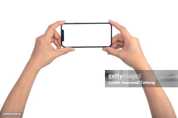 smartphone in female hands taking photo isolated on white background - horizontal stock-fotos und bilder